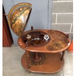 A light mahogany finish mobile globe drinks trolley