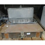 Two military camping stoves in metal travel cases