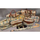 A collection of seven Burberry style ladies bags together with a matching umbrella