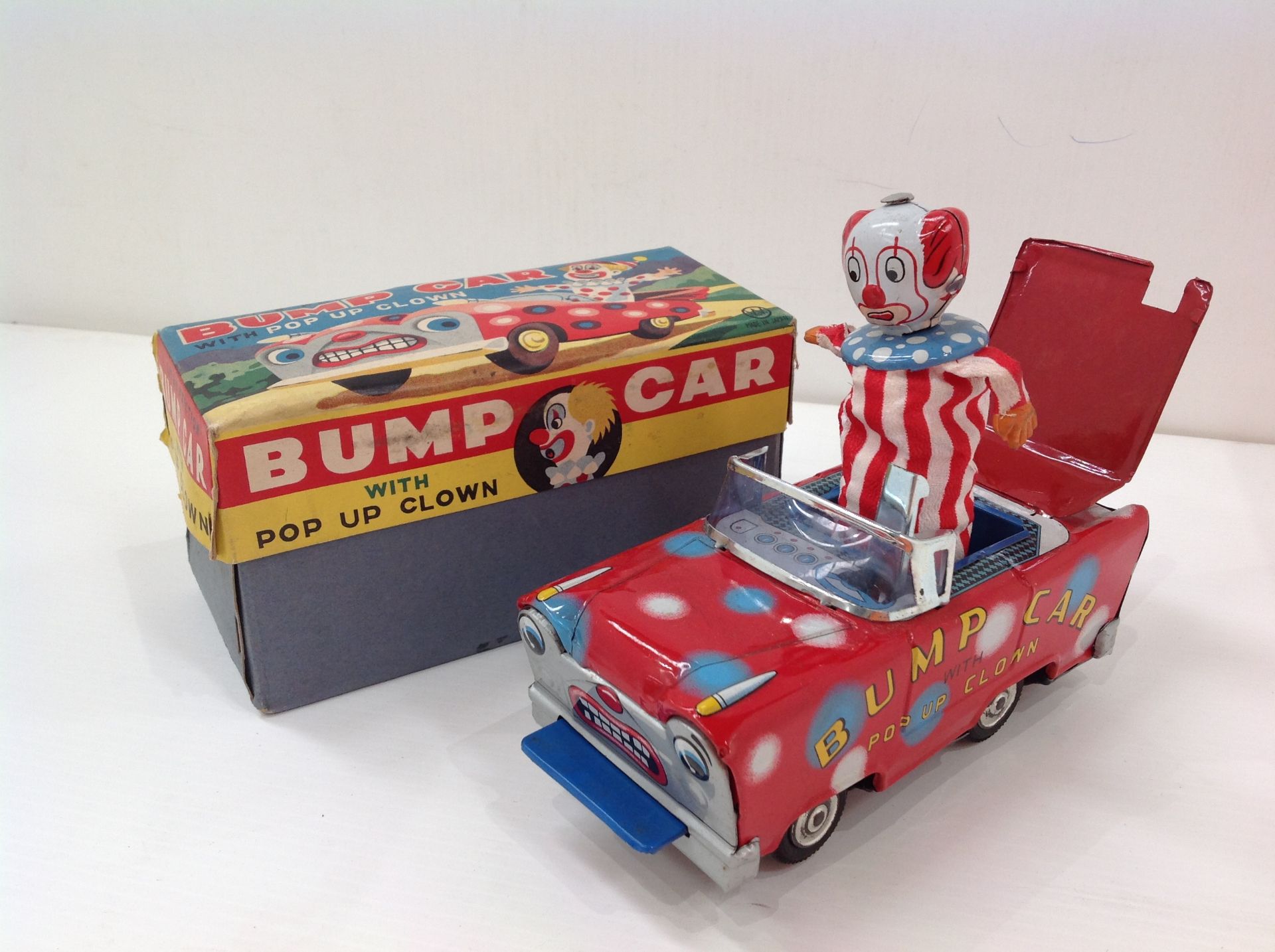 A Wakasuto Toys Japan bump car with pop up clown (boxed)