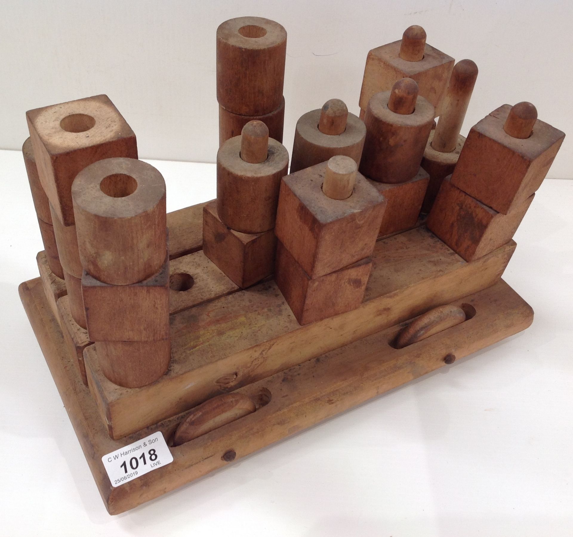 A wooden pull-a-long toy with a quantity of wooden building blocks