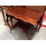 A mahogany side table with under tray