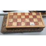 Two wooden board games - chess set with carved wooden pieces and a Turkish back gammon game in an