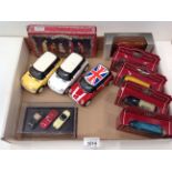 Three die cast 1:24 scale Mini Cooper cars (unboxed), a miniature Jaguar E-Type collection (boxed),