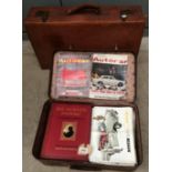 A fibre suitcase containing automobile magazines, vehicle advertising pamphlets,