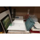 Contents to part of rack - packs of paper, packs of cotton grain canvas,