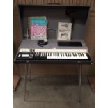 A Gem jumbo cased organ on chrome metal legs complete with manual and a quantity of sheet music