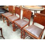 Four oak dining chairs with brown rexine seats