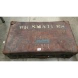 A brown leather suitcase stencilled WK Smailes