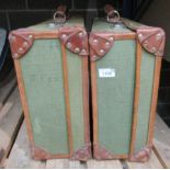 Two vintage suitcases with green upholstery and brown leather trim