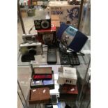 Contents to two glass shelves - Sony Cyber-Shot camera, Canon A470 camera,