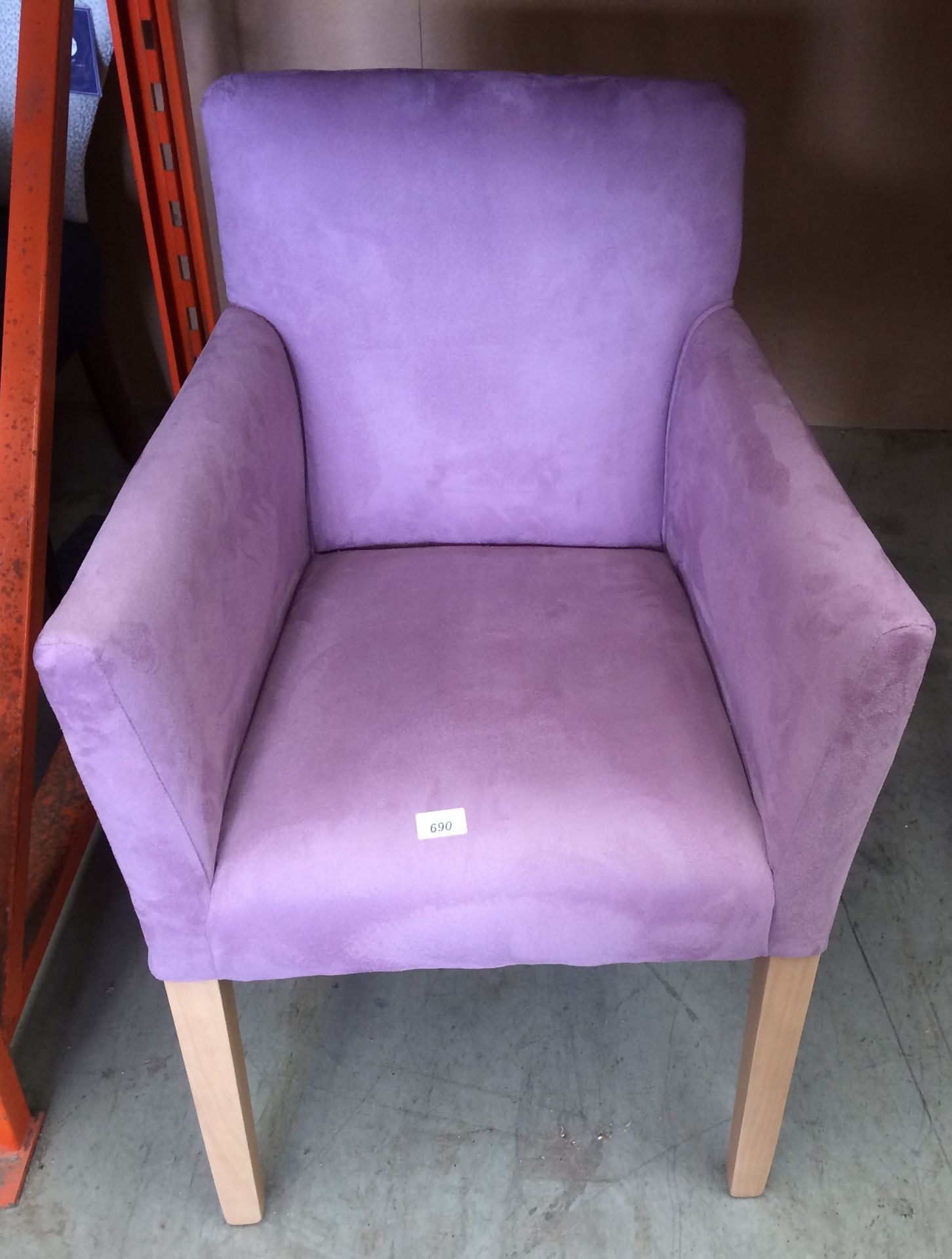 A purple velvet finish upholstered armchair on light wood legs