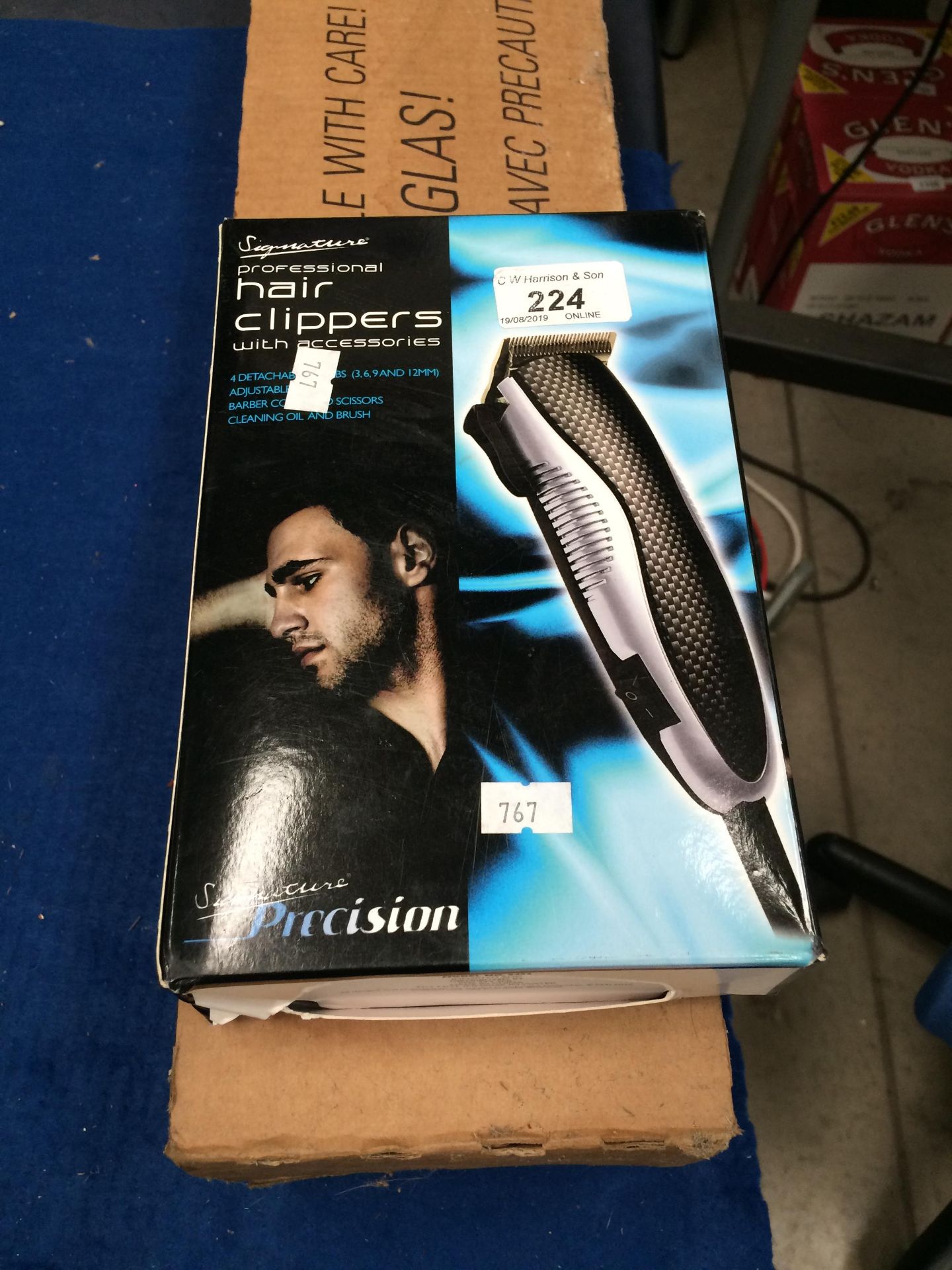 Signature professional hair clippers and a part box of fluorescent tubes