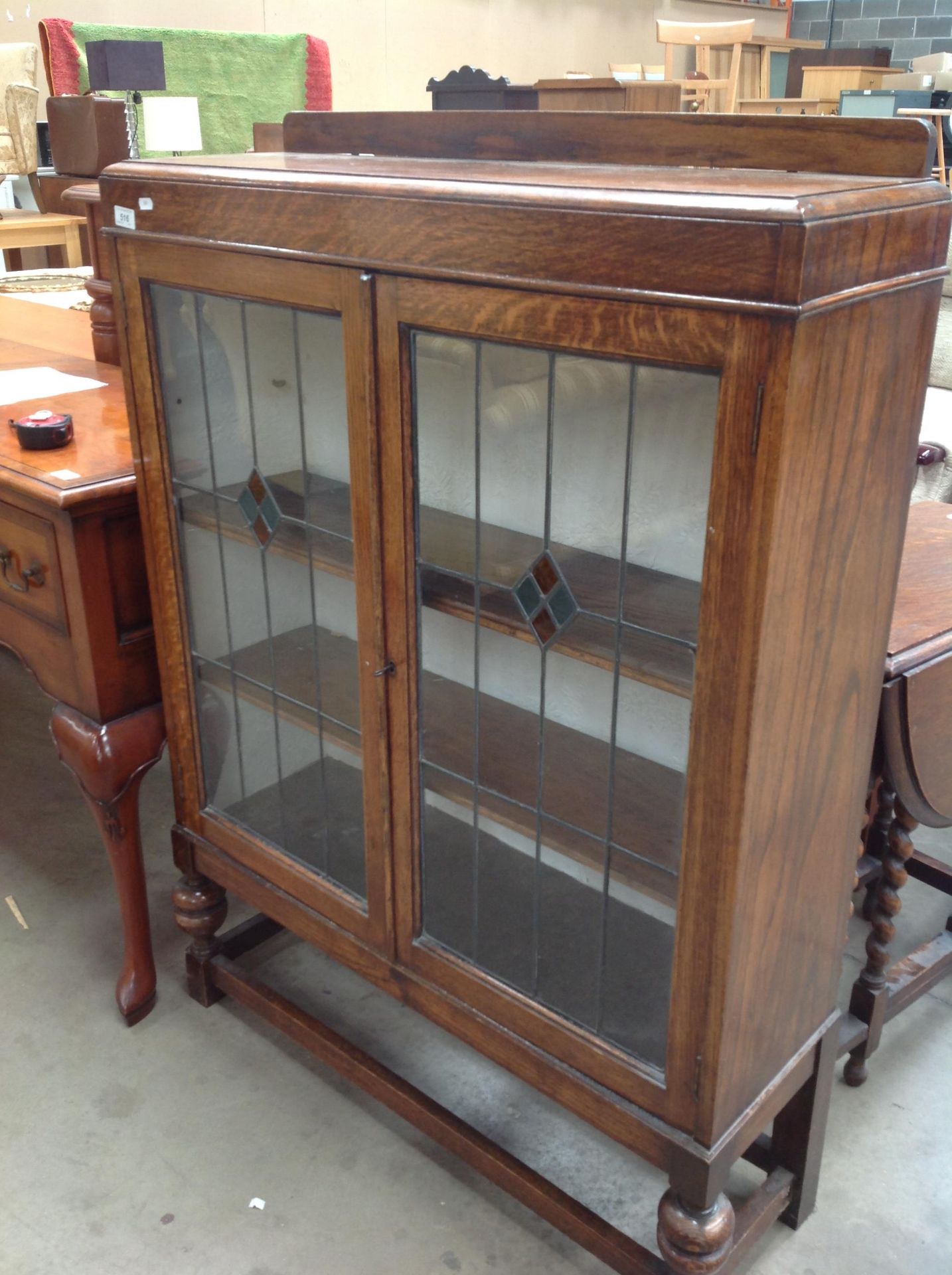 An oak display cabinet with leaded glazed doors 90 x 120cm high