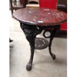 A cast iron metal reproduction Britannia style pub table with dark oak top 60cm dia