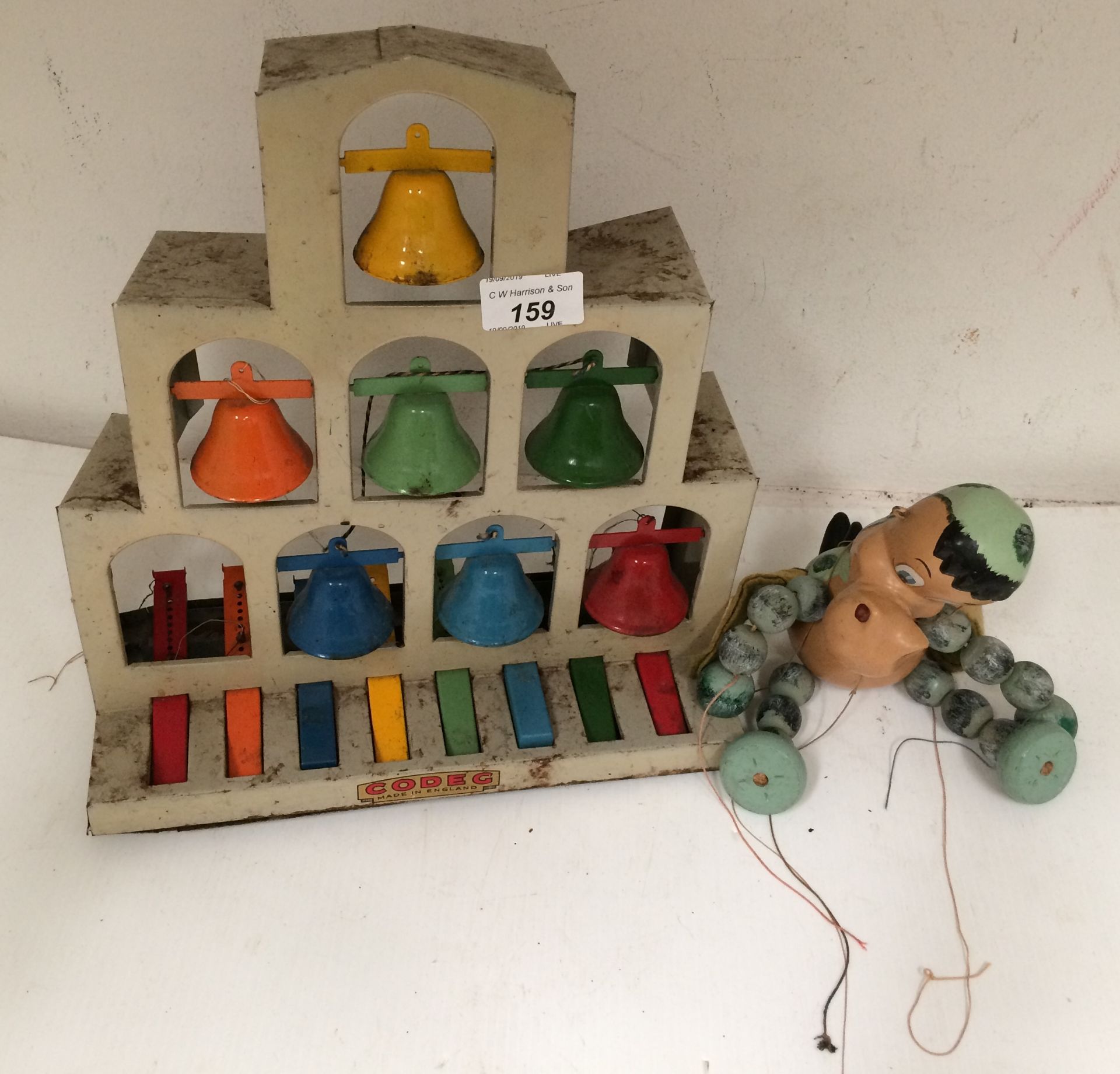2 x items - Codeg tin plate music bells and wooden string puppet