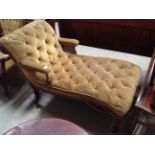 A mahogany framed double arm chaise longue 130cm long upholstered in a light green deep buttoned