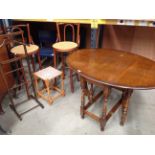 An oak oval drop leaf dining table 90 x 122cm (when open), a pair of bentwood high bar stools,