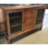 Oak wall cabinet with centre door flanked by two leaded glazed doors 154 x 110cm high