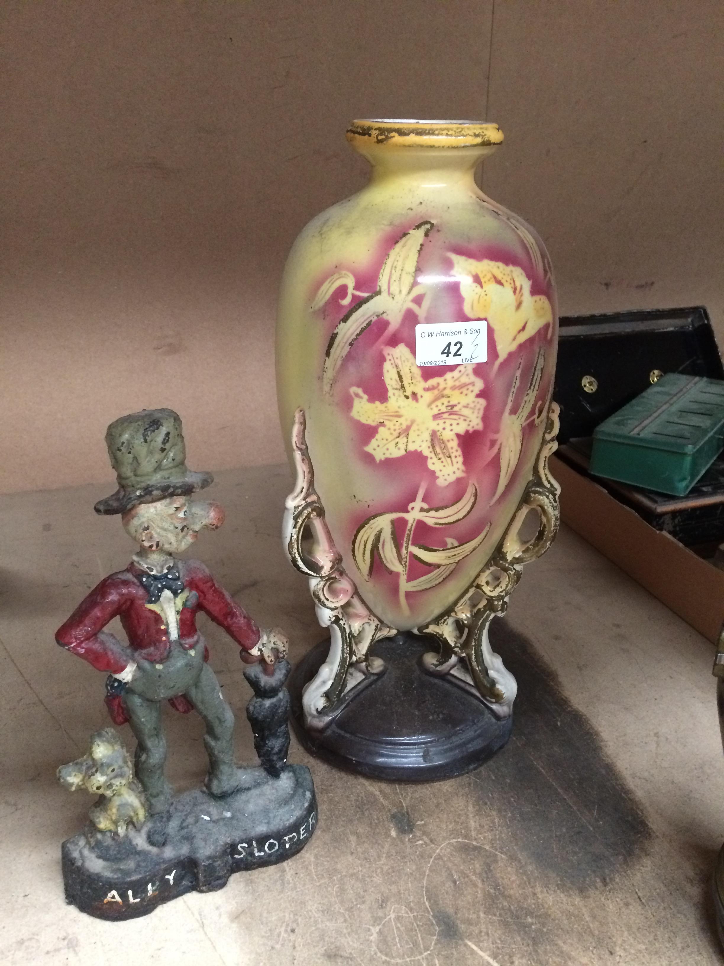 2 x items - cast metal "Ally Sloper" door stop and a Viking yellow and red glazed floral design