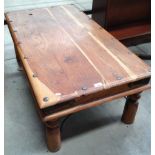 A wood coffee table with metal studded details 110 x 61cm