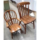 A child's oak reproduction Windsor armchair and a rail back kitchen chair (2)