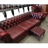 An oxblood leather deep buttoned back three seater Chesterfield (wear to seat pads),