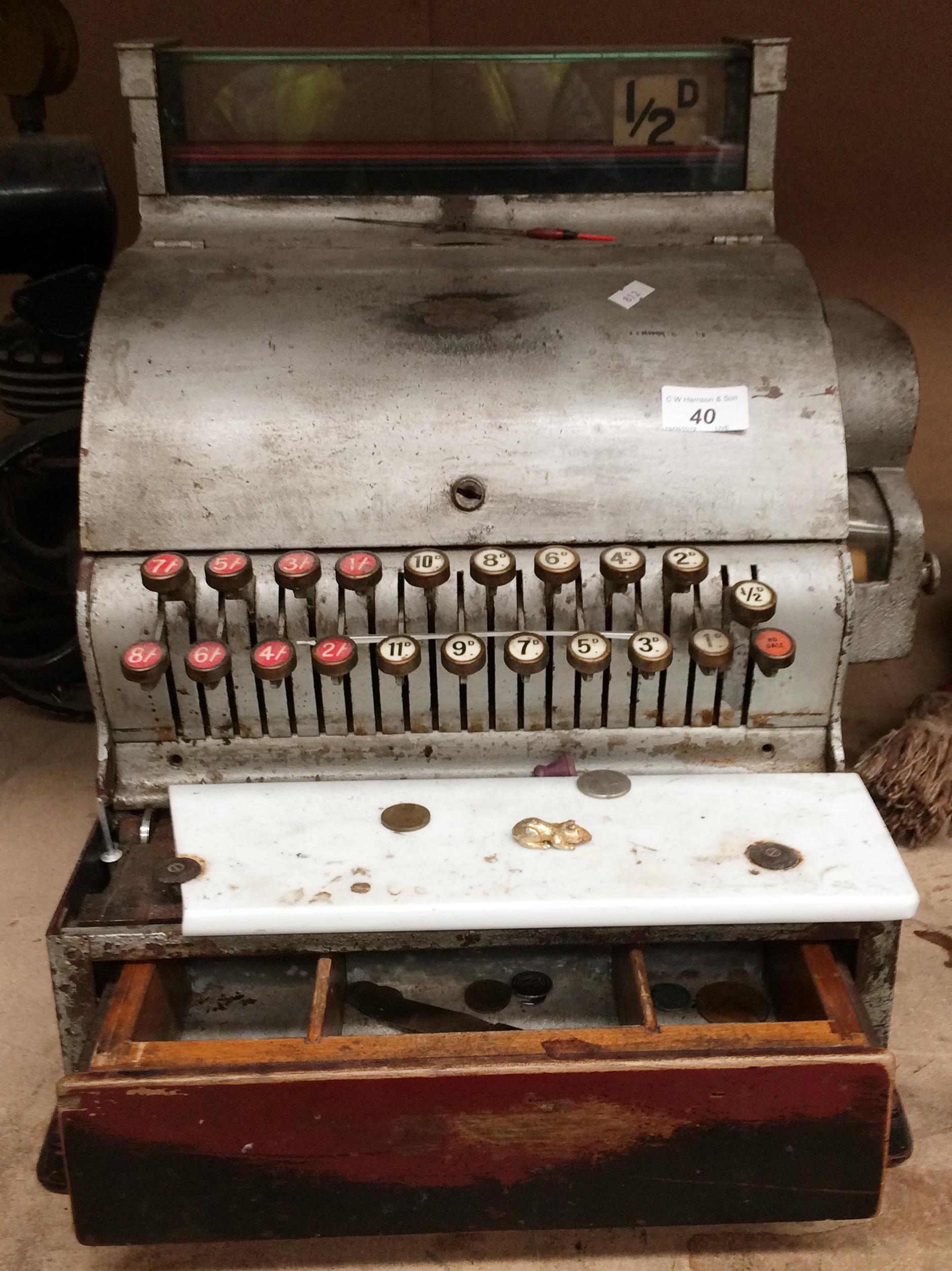 A vintage cash register with wood coin drawer