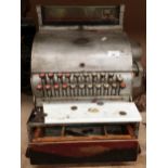A vintage cash register with wood coin drawer