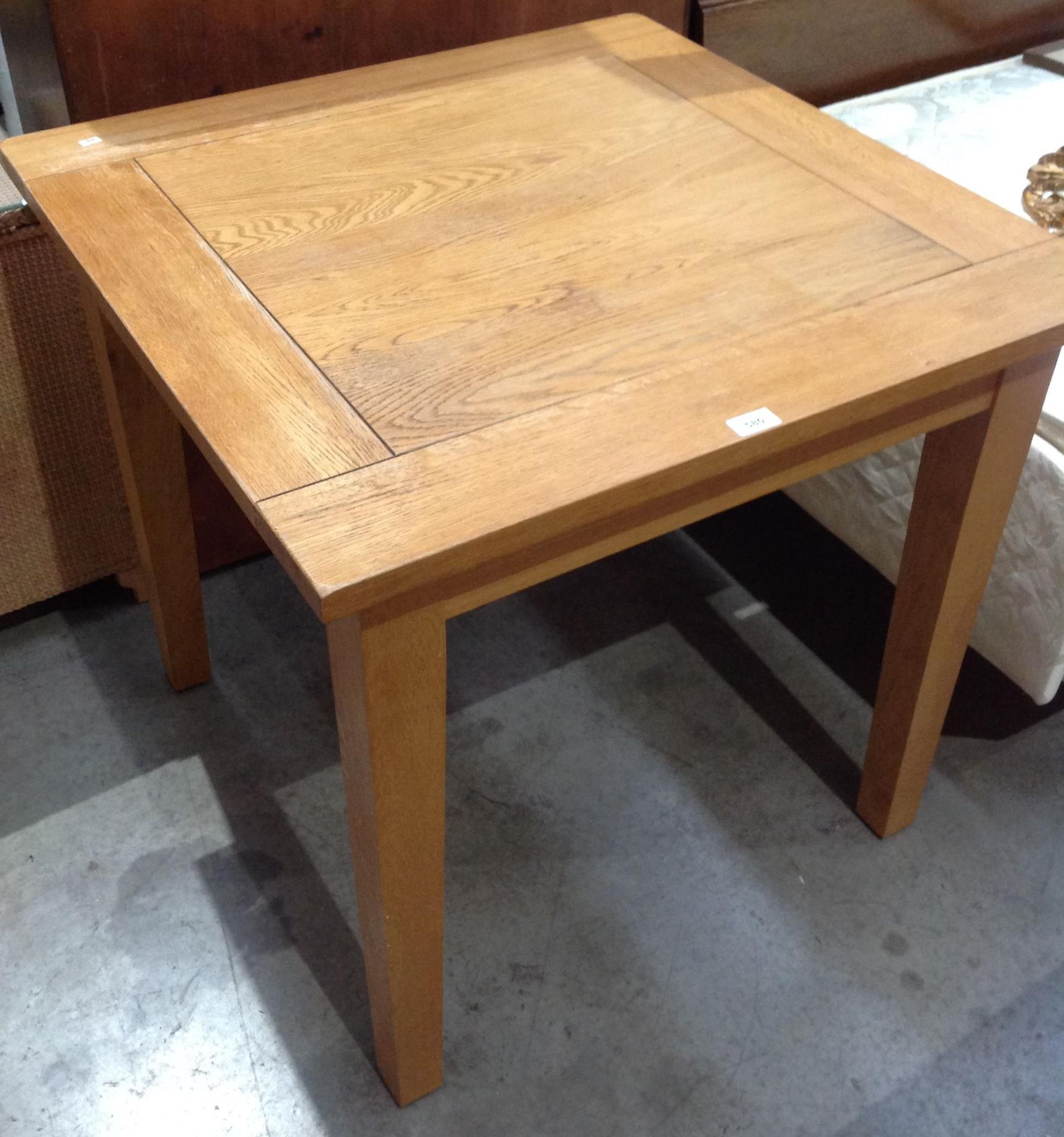 A light oak square dining table 80 x 80cm