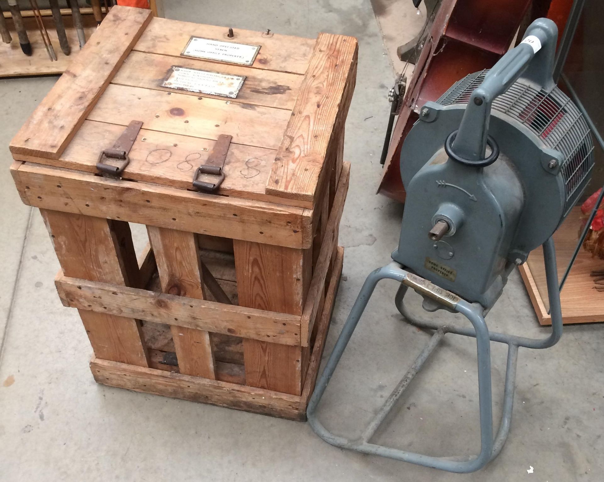 A Secomak 447 hand operated air raid siren together with a wooden travel crate (please note - no