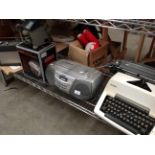 Contents to shelf - Olympia manual typewriter, portable radio, Sony cassette recorder,