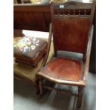 An oak rocking armchair with shell pattern seat and back and mahogany footstool with floral