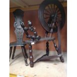 An oak framed spinning wheel with damages and a carved back oak framed Welsh stool (2)