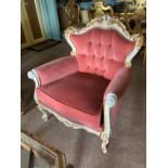An ivory and gilt ornate framed continental style armchair with pink dralon upholstery