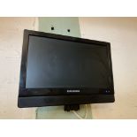 A Grundig 16" wall mounted flat screen TV complete with remote control and bracket