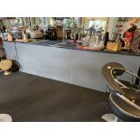 A grey painted long bar with black marble effect work top incorporating a sideboard and storage