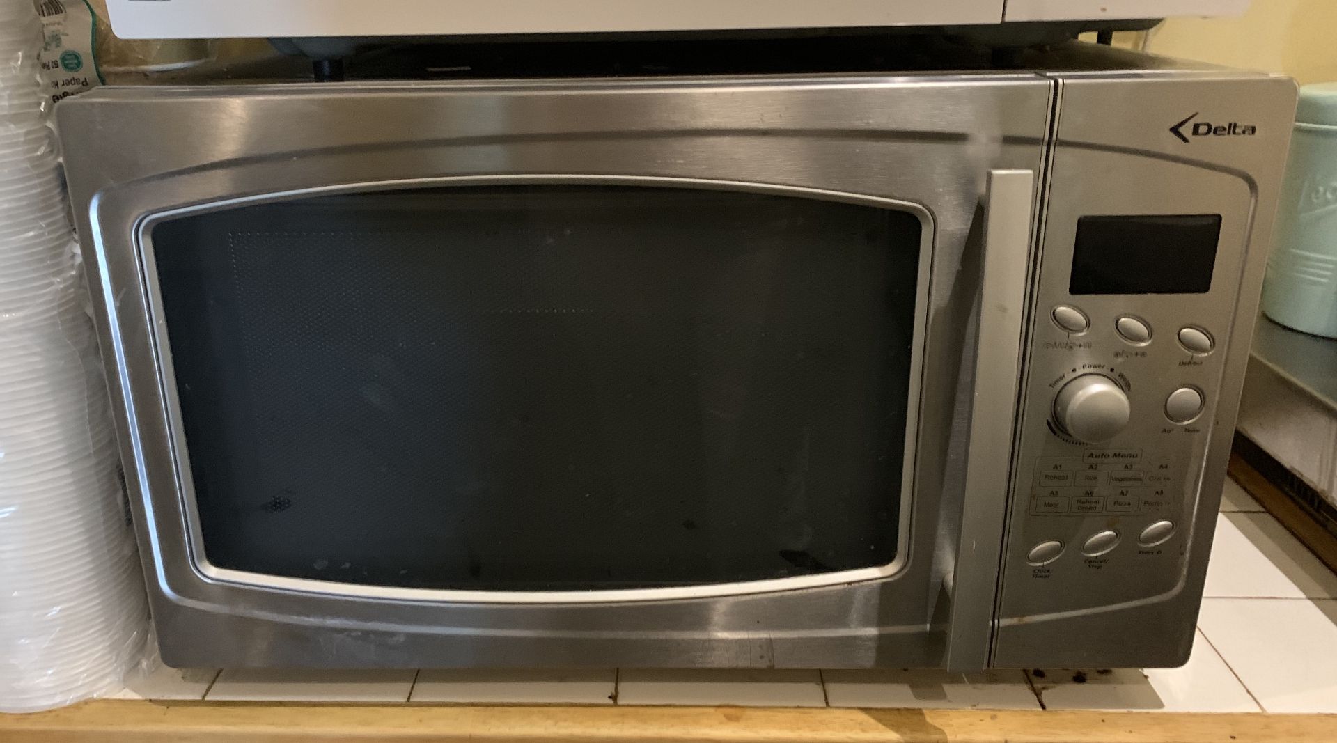 A Delta microwave oven - silver coloured