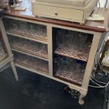 A mahogany topped glass storage cabinet on cabriole legs 140 x 50cm