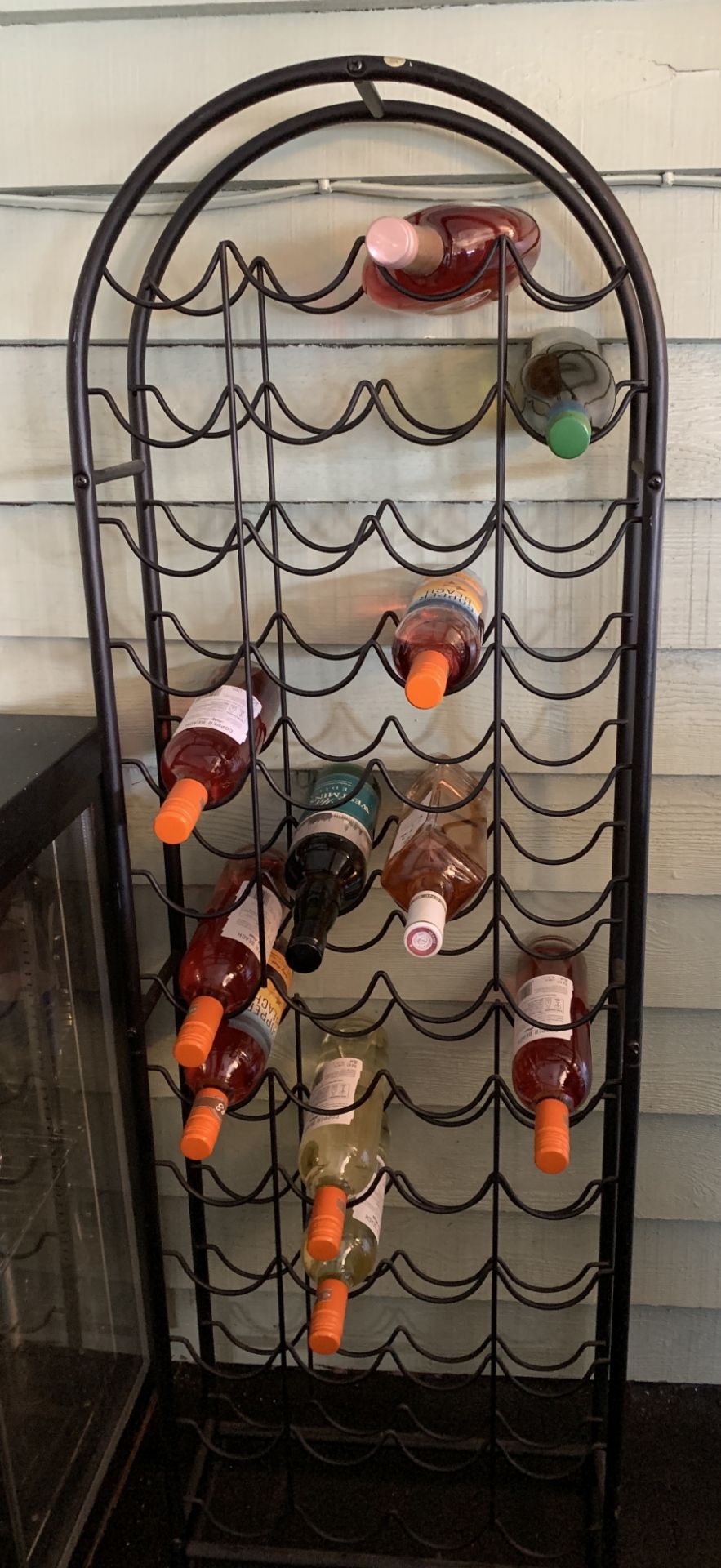 Metal framed arch top 52 bottle wine rack (bottles in picture not included in the lot)