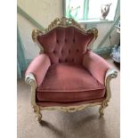 An ivory and gilt ornate framed continental style armchair with pink dralon upholstery