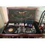 A Baccarat table top games compendium set complete with a small box of chips