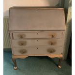 A grey and gilt painted bureau with fall flap over three drawers 87cm long