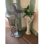 A white floral patterned jardiniere on pedestal and a freestanding oscillating fan (2)