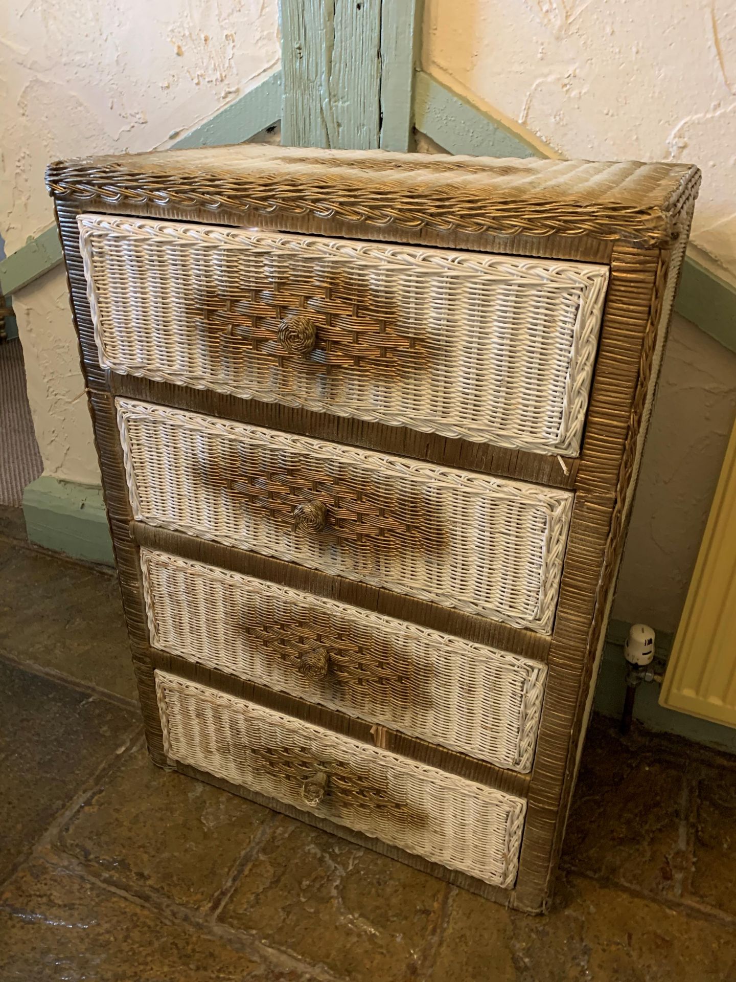 A Lloyd Loom style white and gilt spray painted four drawer chest of drawers 70cm