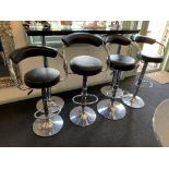 Four chrome framed black vinyl upholstered adjustable swivel bar stools