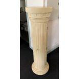 A beige painted free standing plinth/CD cabinet