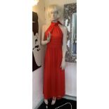 A full size composite female mannequin - no base but complete with wig and red dress