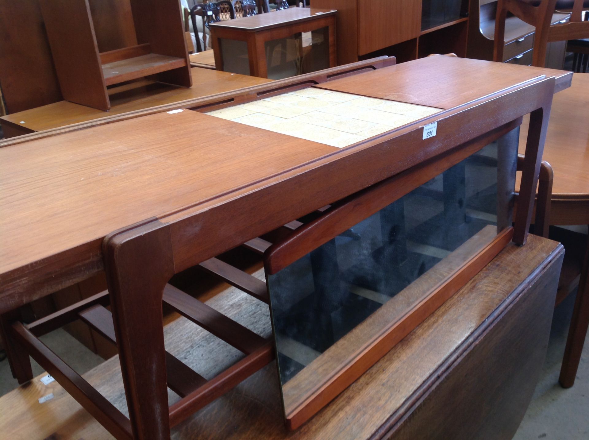 A tiled teak sliding top coffee table and small teak framed mirror