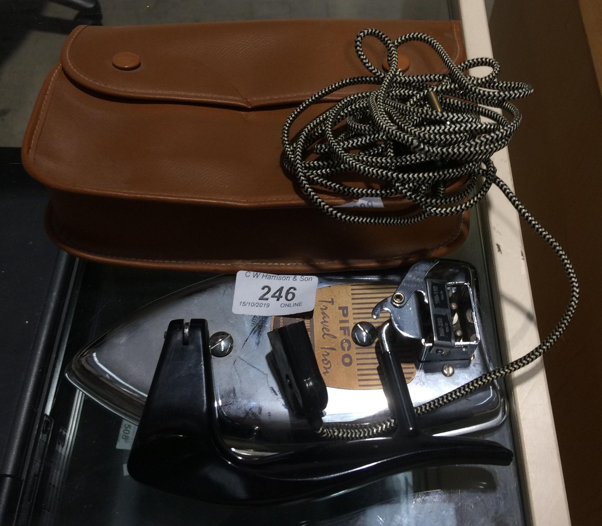 A Pifco 200w travel iron in brown case